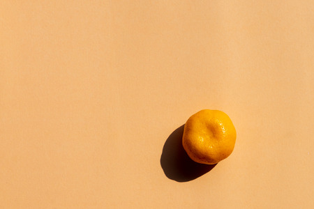 top view of a whole oranges with strong shadow on orange background, copy spaceの写真素材