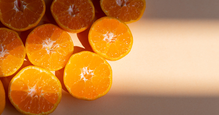 Top view fresh orange slices on cream background . Copy Space. creative summer concept. Half of citrus in minimal, Bannerの写真素材