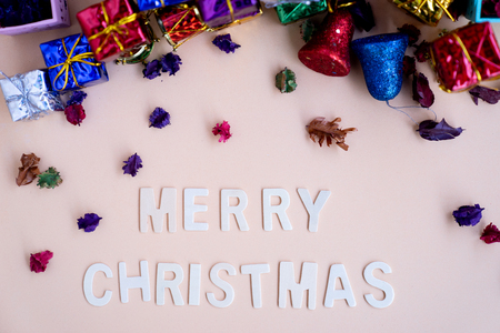 merry christmas wooden word  with colourful christmas gift boxes in background, for bannerの写真素材