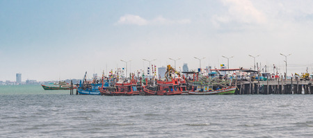 small and big wooden fishing craft boats were docked at local fishing pier at Bang Saray,a beautiful idyllic fishing village in Pattaya, Thailand.のeditorial素材