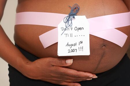 Pregnant Belly With Ribbon and Gift Tagの写真素材