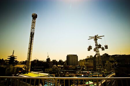 A small amusement park in the urban city of tokyo in the morningのeditorial素材