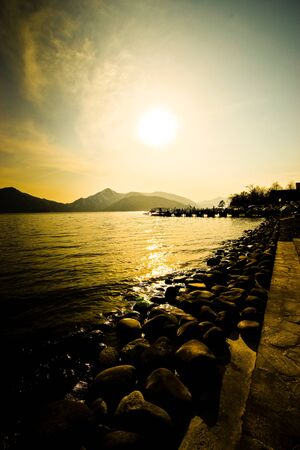 Lake Chuzenji in the evening with the setting sun in the backgroundの写真素材