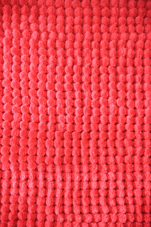 Red fabric dotted texture of a floor matの写真素材