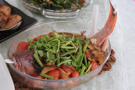 Steamed fish arranged on a glass platterの写真素材