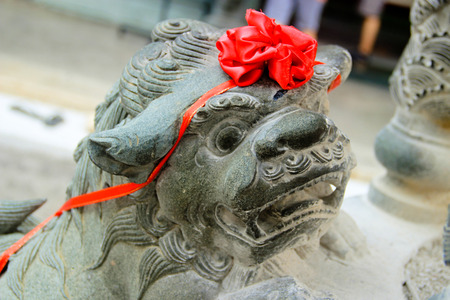 Stone Lion guarding the chinese temple in penang malaysiaの写真素材