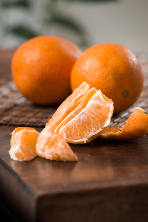 Fresh tangerines and slices composition on warm backgroundの写真素材