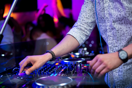 Party people Dj playing music on the turntable with the hands on the mixer console. Cool disc jockeyの写真素材
