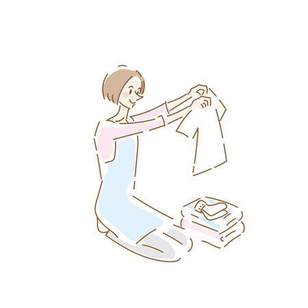Cute housewife folding laundryのイラスト素材
