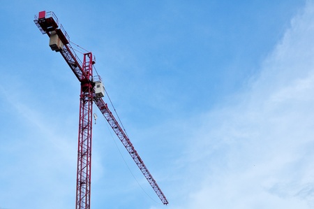 Tall red crane on Construction siteの写真素材