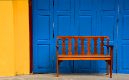 Vintage wooden chair with blue vintage door backgroundの写真素材