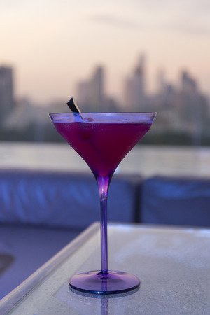 Red martini with cityscape backgroundの写真素材