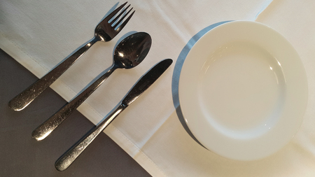 White dish with spoon and fork prepare for mealの写真素材
