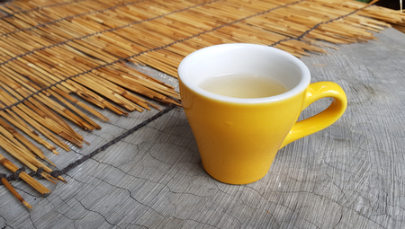Little yellow cup of white teaの写真素材