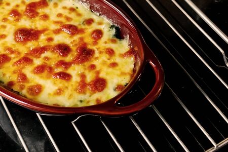 Baked spinach with grilled mozzarella cheese on top cuisineの写真素材