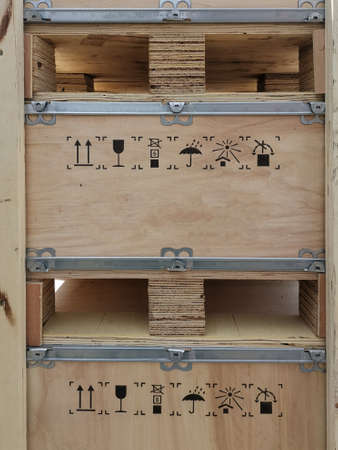 Wooden container box with pallet and warning delivery symbol painted on it for shipping.の写真素材