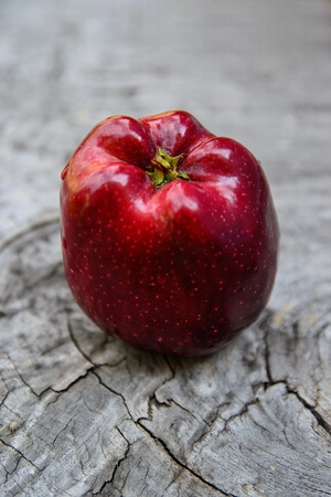 Fresh red apple on the wooden table
