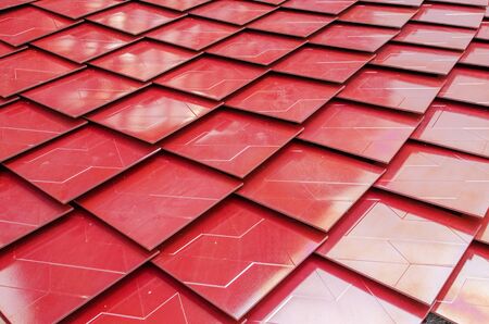 Red metalized roof tiles backgroundの写真素材