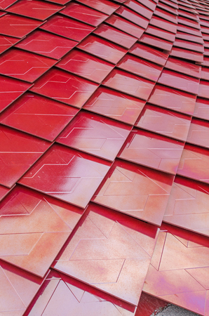 Red metalized roof tiles backgroundの写真素材
