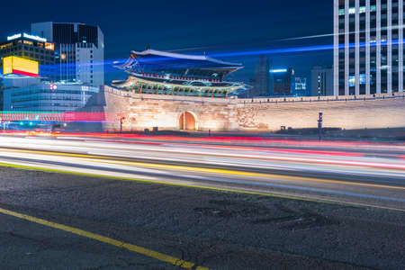 Korea,Traffic blurs past Namdaemun Gate in Seoul, South Korea.のeditorial素材