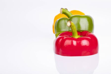Red, green, yellow bell pepper on a white background.の写真素材