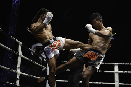 SATTAHIP, THAILAND- APRIL 6 : Between the punch  in Thai Fight : Muay Thai..World's  between Sudsakorn Sor.Klinmee (thailand) VS Cody Moberly (canada) in Thai Fight : Muay Thai..World's Unrivalled Fight on April 6, 2014 at King of muay thai , Chonburi , Tのeditorial素材