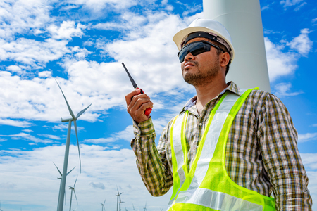 Engineer worker at wind turbine power station construction site.の写真素材