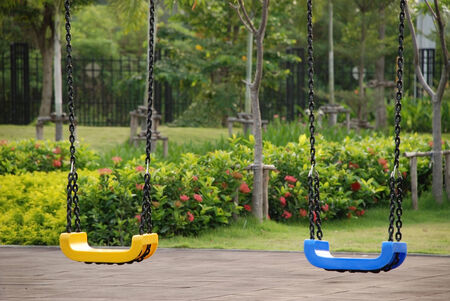 Yellow and blue Swing on the playgroundの写真素材