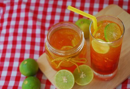 lemon tea in a glass on plaid tableclothの写真素材