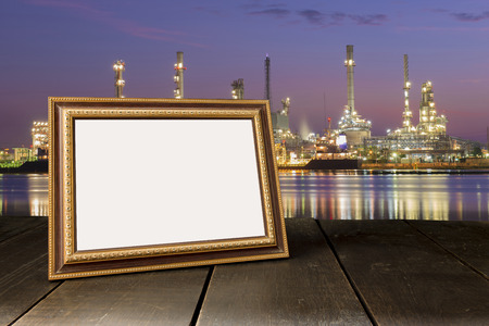 Vintage photo frame on wooden table over cityscape at twilight time backgroundの写真素材