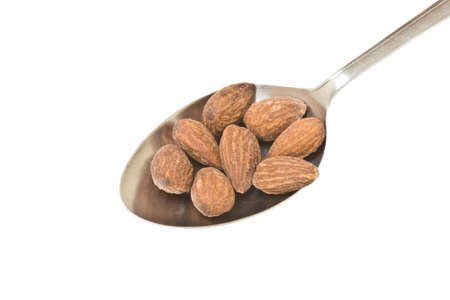 Almond in the spoon on white の写真素材