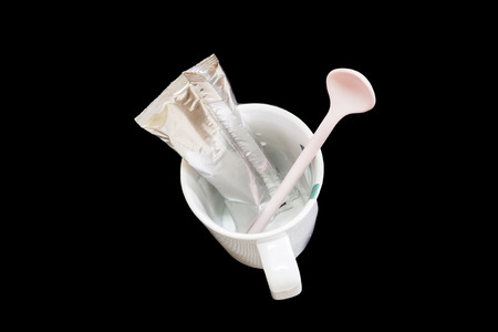 packaging aluminum foil coffee stick pouch and cup isolated on blackの写真素材