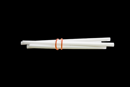 white drinking straws isolated on black backgroundの写真素材