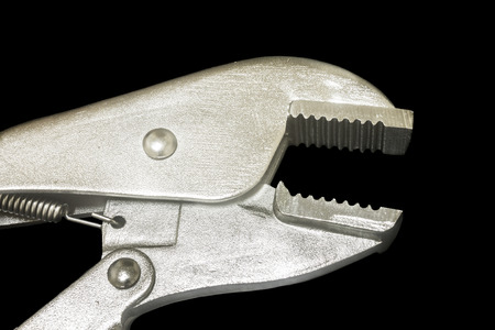 Locking Pliers isolated on black backgroundの写真素材