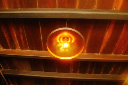 lantern lights hanging from wooden ceilingの写真素材
