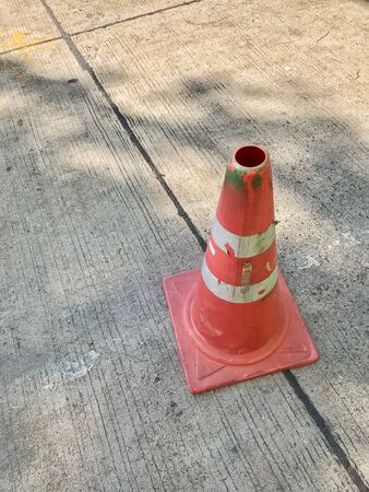 Orange traffic cone with reflective stripesの写真素材