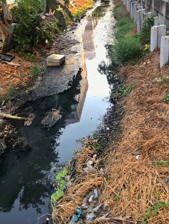Polluted canal and dirty sewer in an urban areaの写真素材