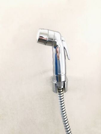 Bidet spray in toilet on the brown backgroundの写真素材
