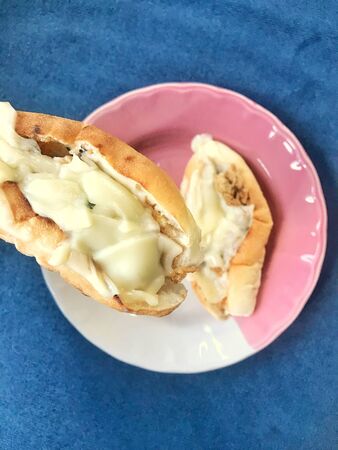 Bread baked with cheese in dishの写真素材
