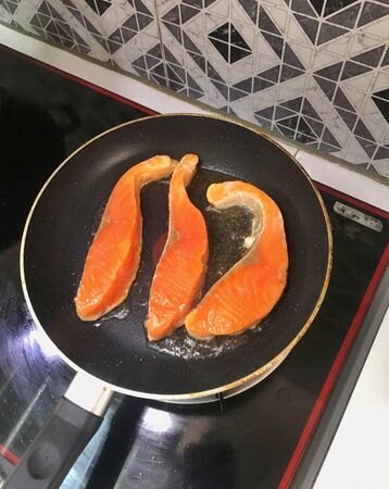 Salmon frying in pan. Cooking salmon steakの写真素材