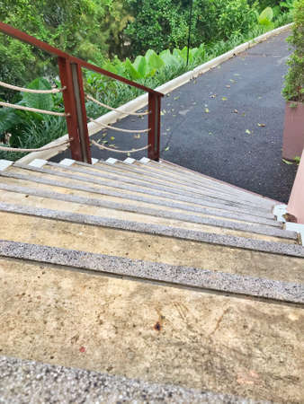 Outdoor concrete staircase with iron handrail