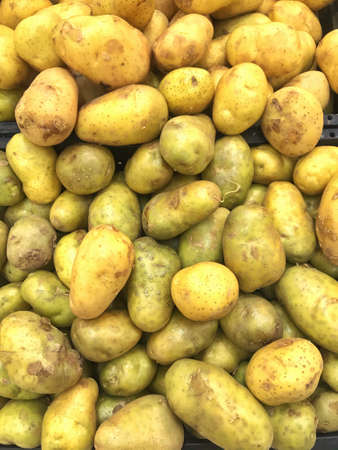 Fresh potatoes on the supermarket shelf.の写真素材