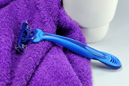 blue razor on purple towel,shallow focusの写真素材