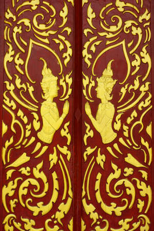 various of thai patterns on temple wall and pillars that  usually present in red,black and gold colourの写真素材