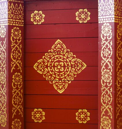 detail of thai pattern that made by covered wood plate with gold leaf for decorated temple door or pillar,shallow focusの写真素材