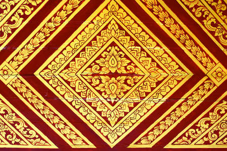 detail of thai pattern that made by covered wood plate with gold leaf for decorated temple door or pillar,shallow focusの写真素材