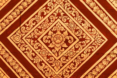 detail of thai pattern that made by covered wood plate with gold leaf for decorated temple door or pillar,shallow focusの写真素材