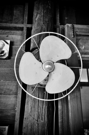 Green old electric wall fan on wood wallの写真素材
