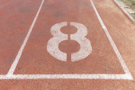 Start track. Lanes 8, number eight of a red racing track.の写真素材