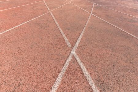 Sport background. White break lines on red tracksの写真素材